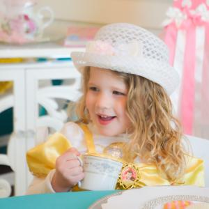 Little girl sipping tea with friends at a tea party